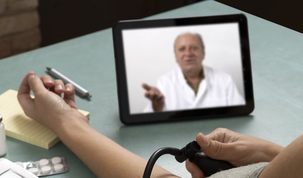 Doctor on tablet explaining remote monitoring device